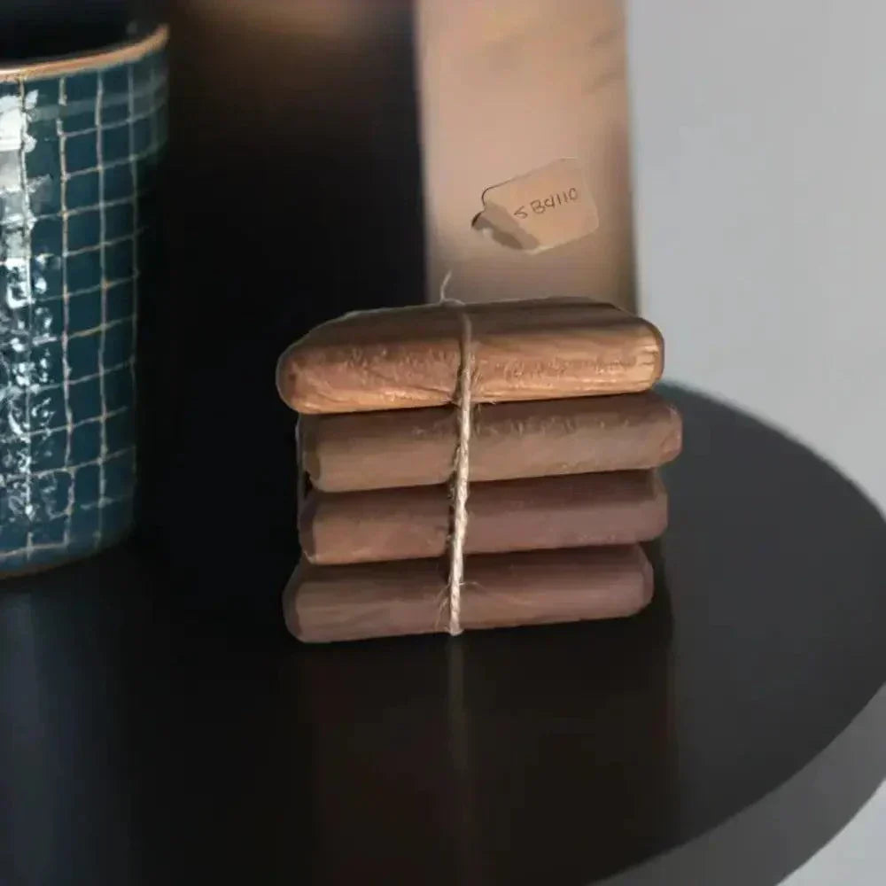 Handmade cherry drink coasters wood stacked, showcasing natural grain on a smooth black surface.