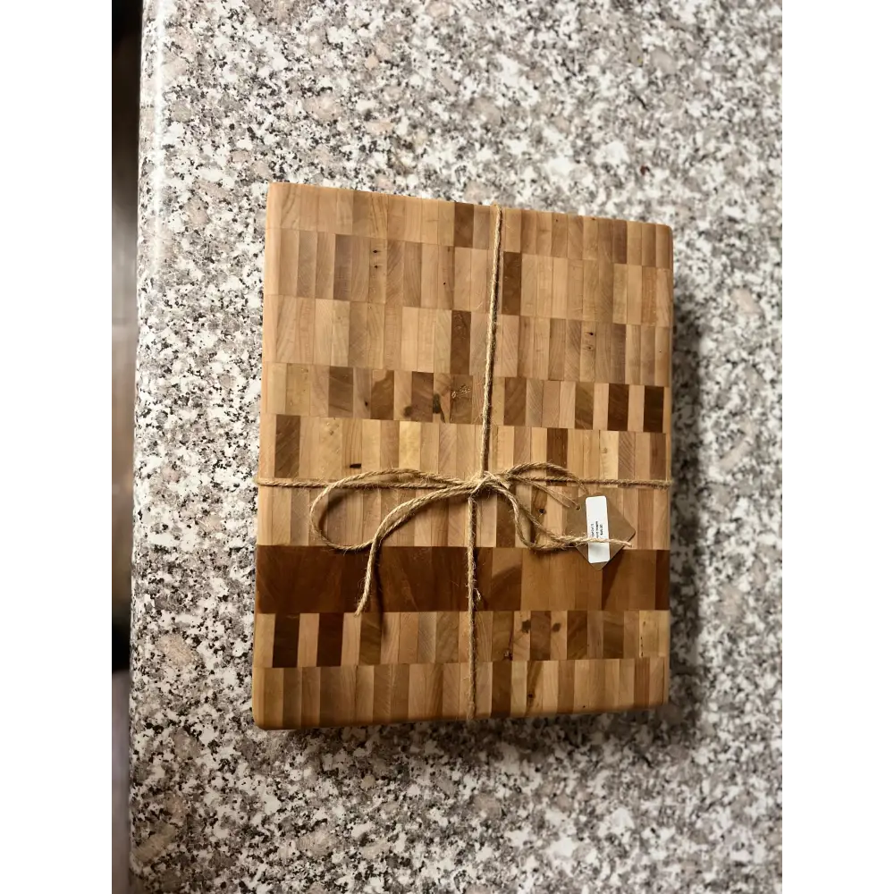 Premium Handcrafted Butcher Block made of Hard Maple with non-slip feet, 10"x12"x1.5", displayed on a granite countertop.