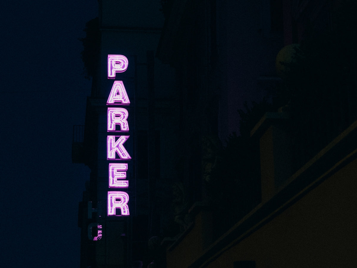 lit Parker neon light signage on a side of a building