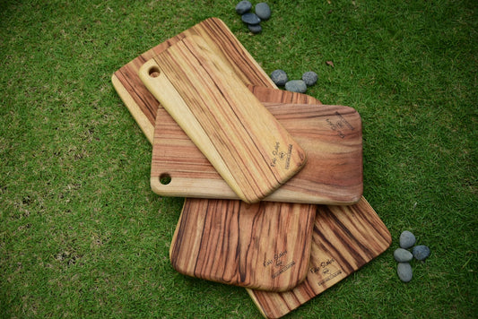 a couple of cutting boards sitting on top of a green field