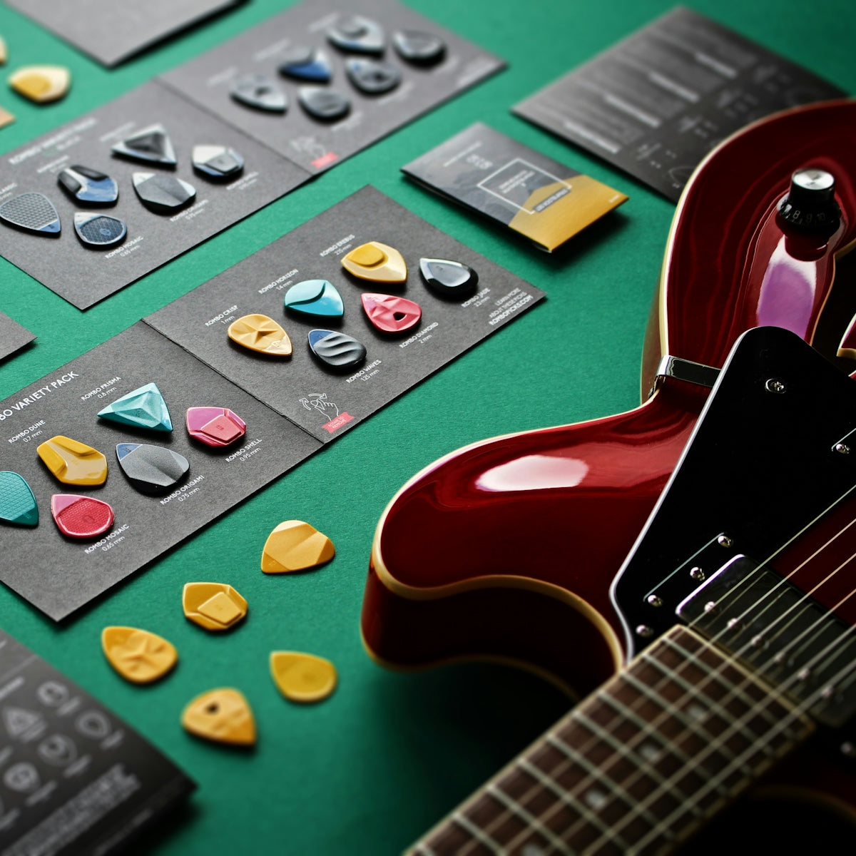 a green table topped with lots of guitar picks