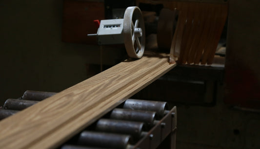a close up of a machine that is cutting wood
