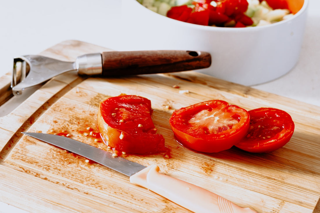 a wooden cutting board topped with sliced tomatoes