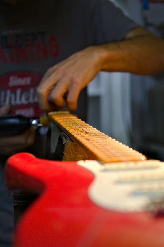A close up of a person cutting a piece of bread