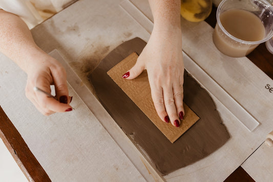 A woman is working on a craft project