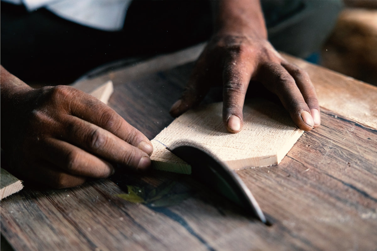 A person is working on a piece of wood