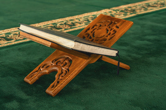 A wooden stand with a book on top of it