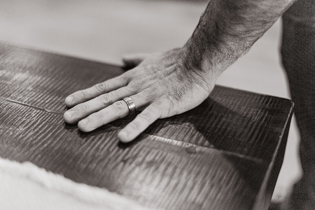 A man with his hand on a piece of luggage