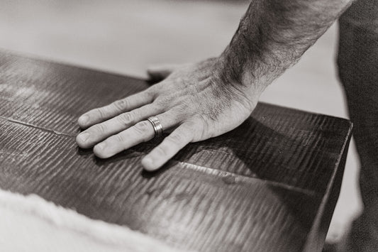 A man with his hand on a piece of luggage
