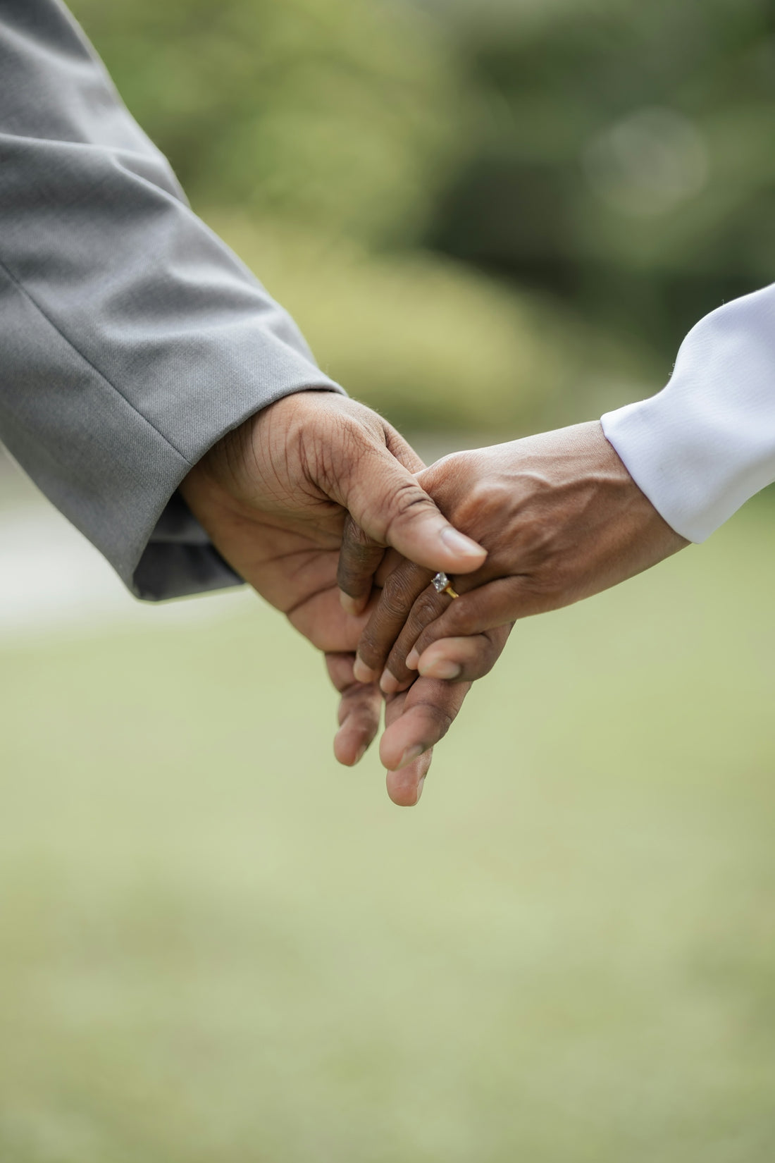 A close up of two people holding hands