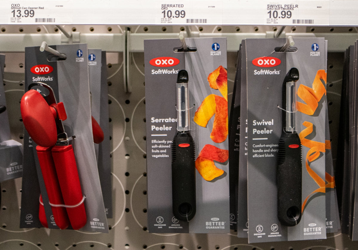 Kitchen tools are displayed on a store shelf.