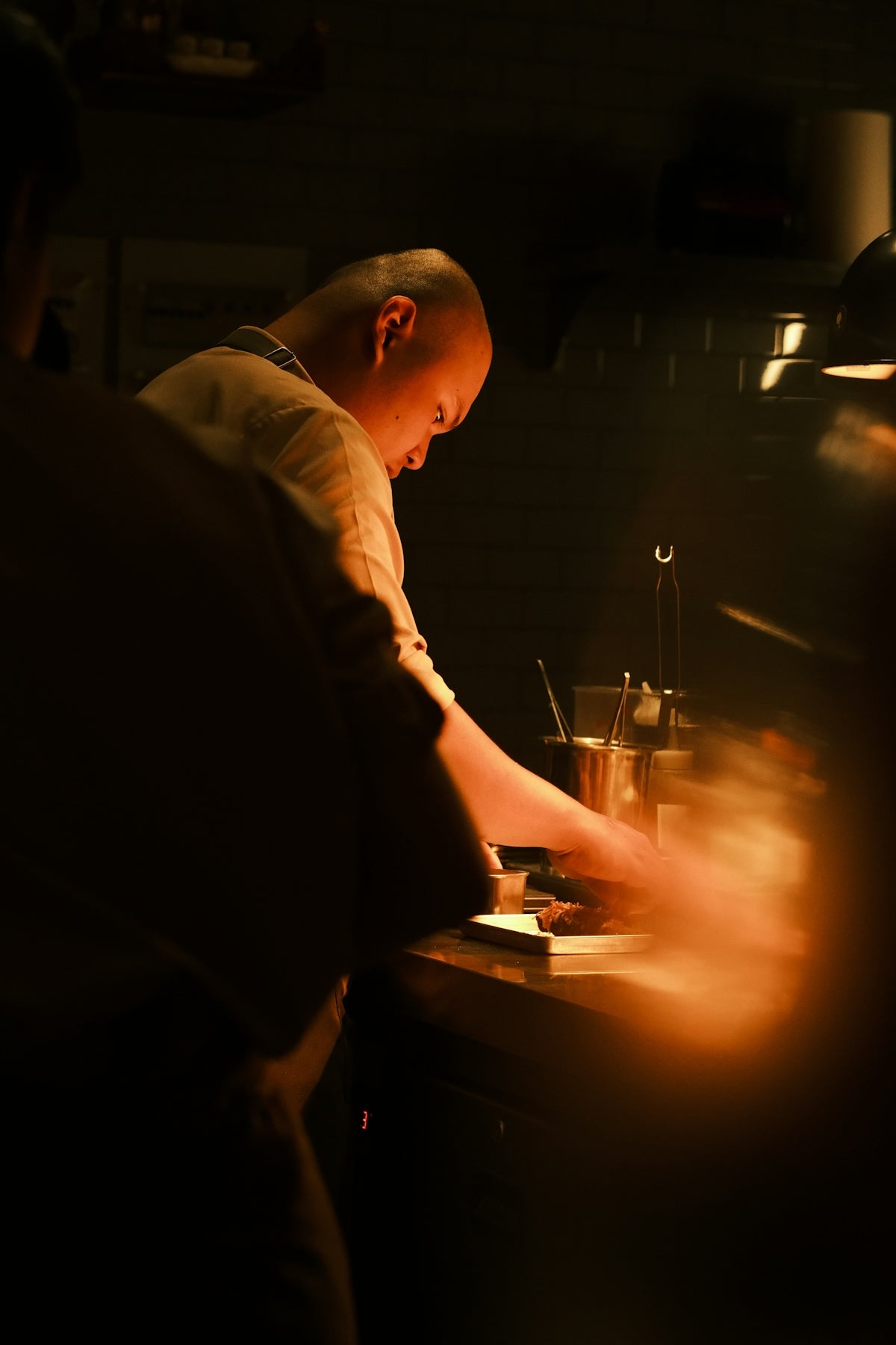Chef working in a dimly lit kitchen