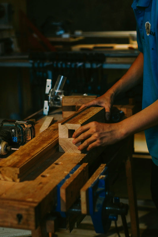 Carpenter working with wood in a workshop.