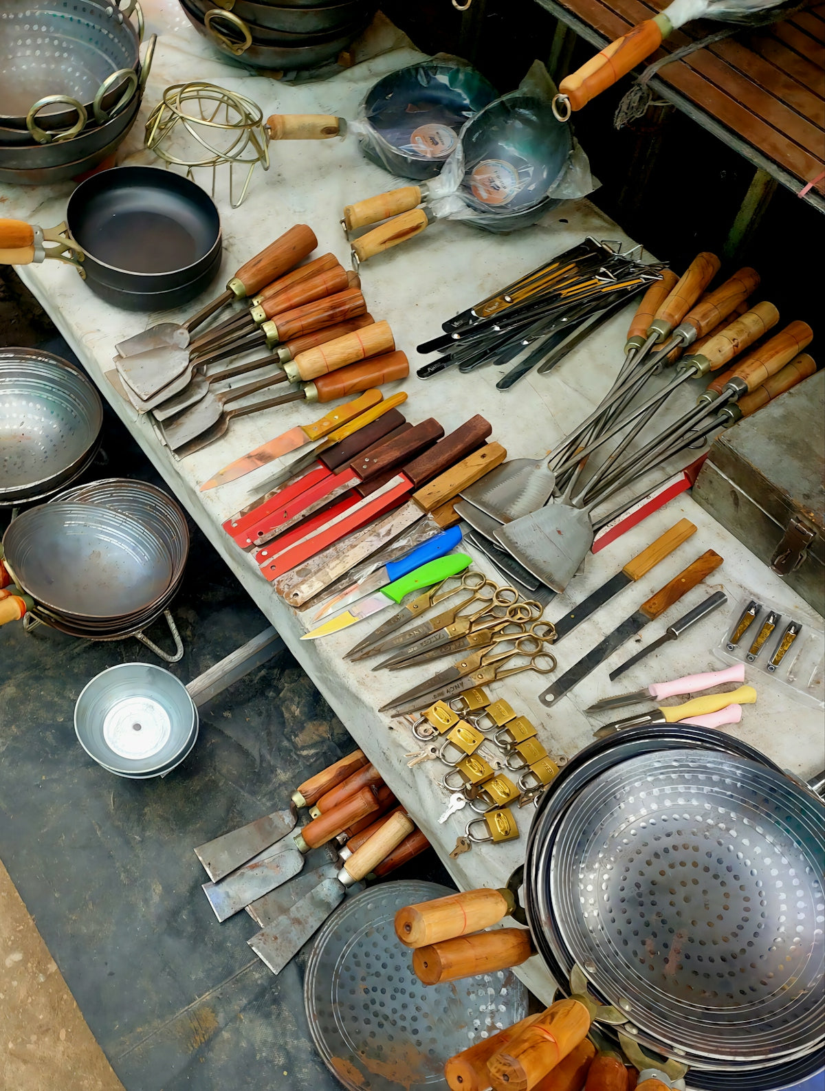 Assortment of kitchen utensils and cookware displayed on a table.