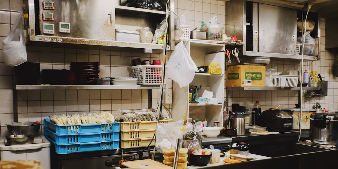 Busy kitchen counter with shelves and containers
