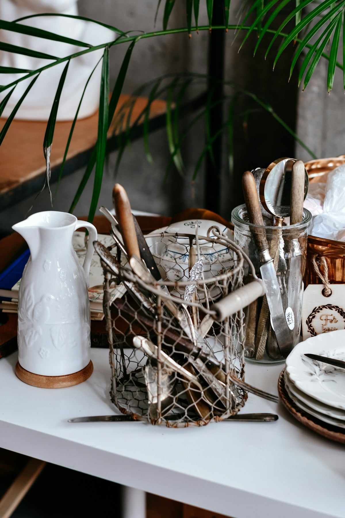 Kitchen utensils in wire holder with white pitcher