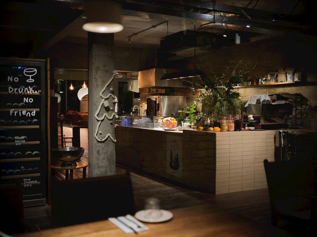 Interior of a restaurant kitchen with dining area in foreground