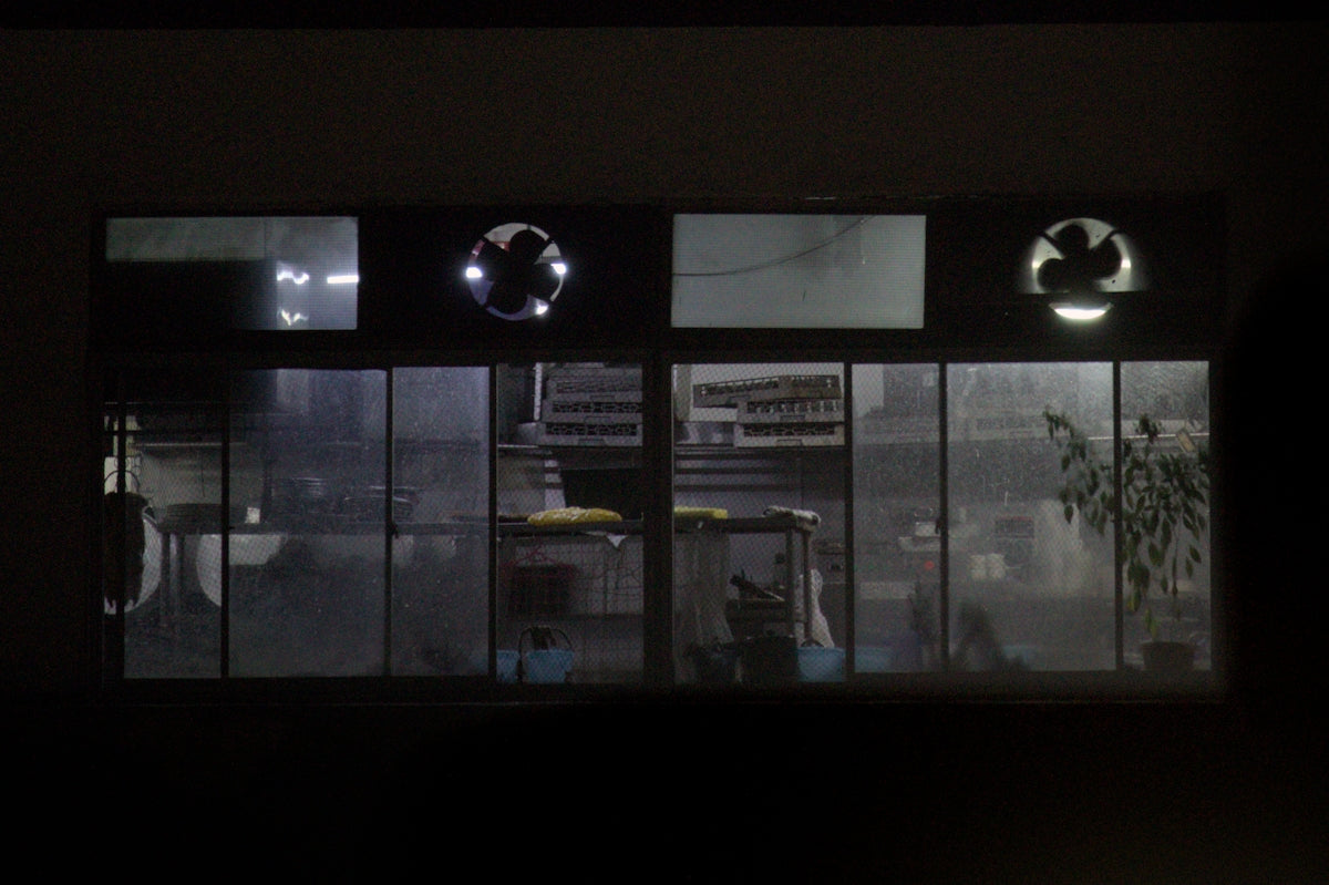 View through a window at night with lights on
