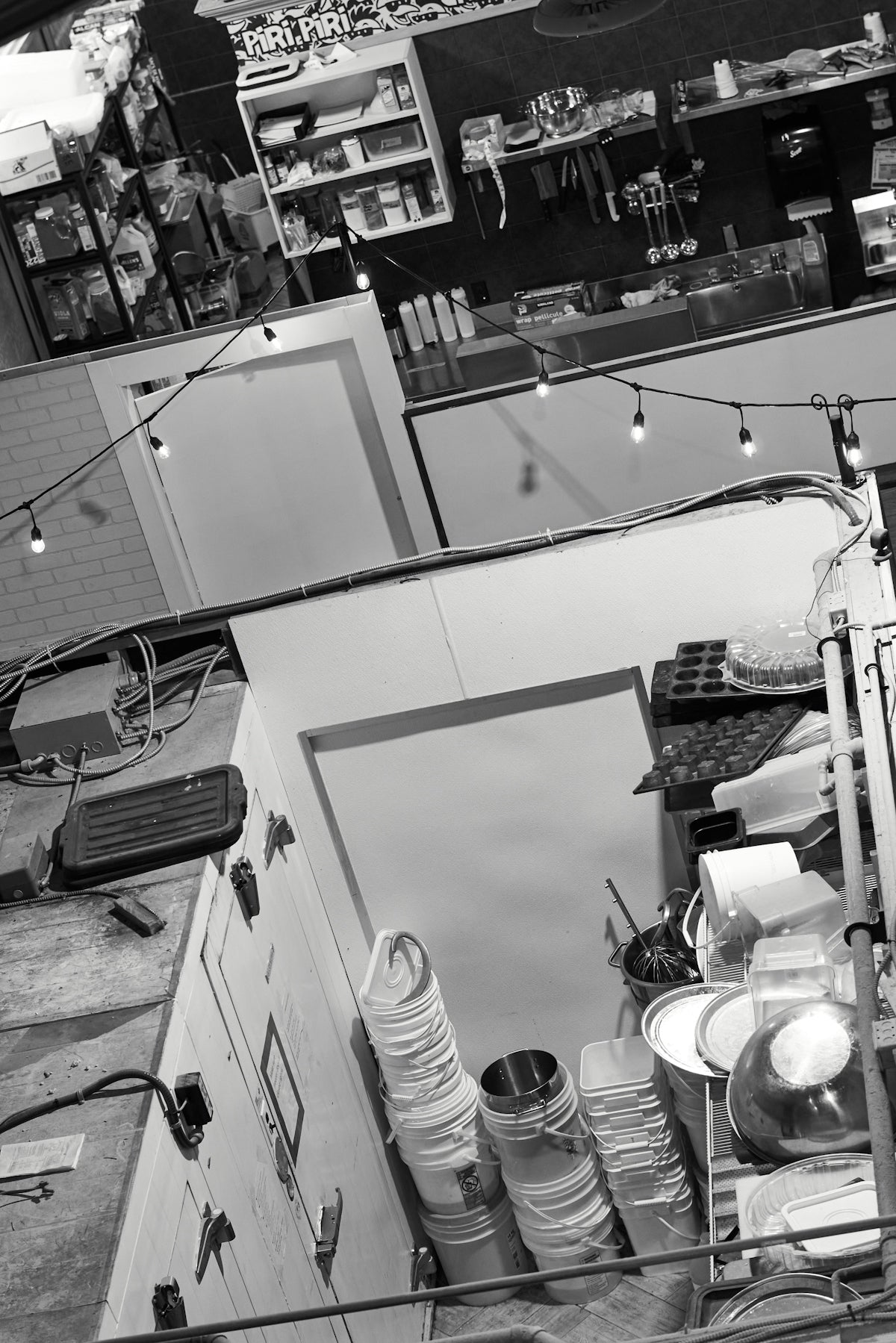 Interior of a cluttered workshop with buckets and tools.