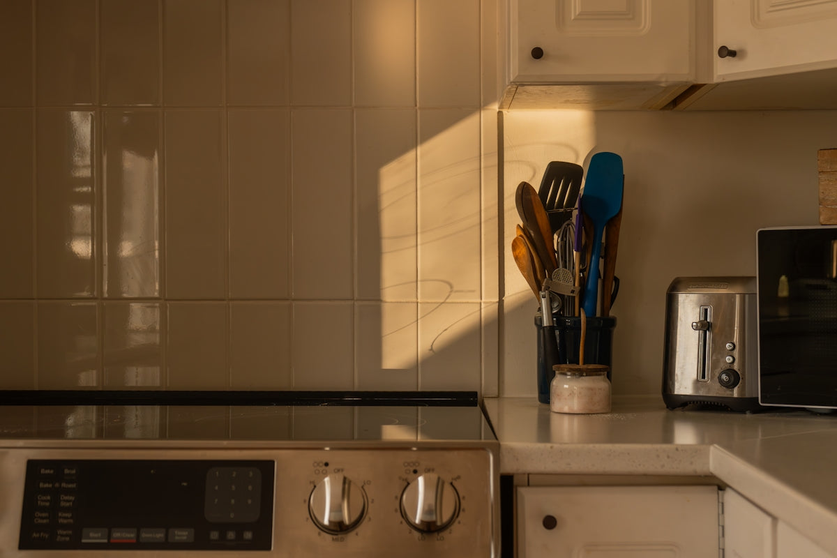 Kitchen counter with utensils and toaster at sunset