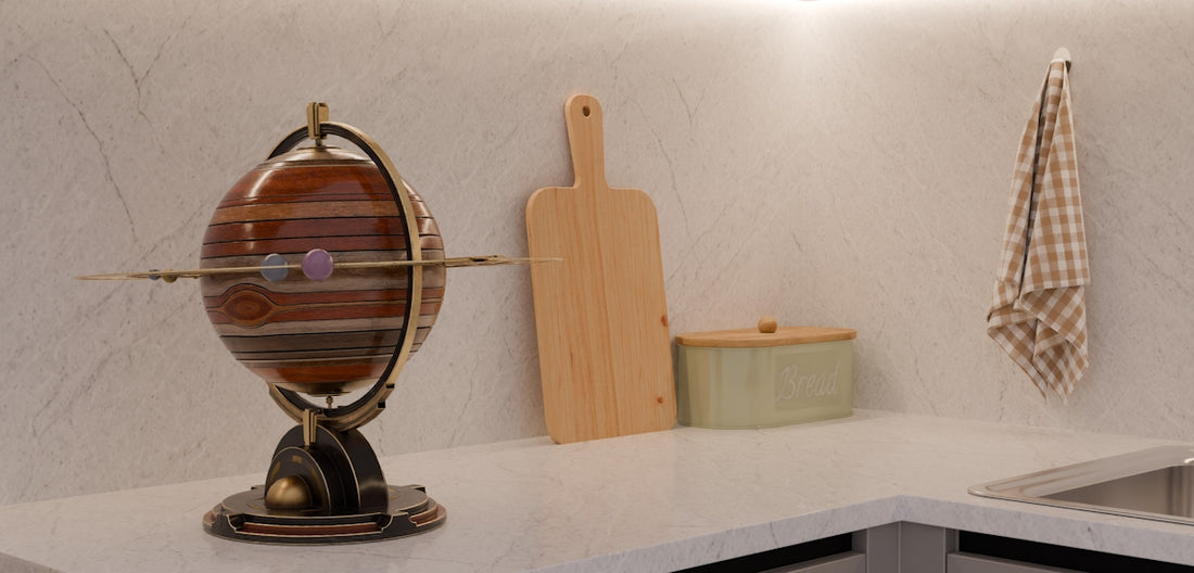 Kitchen counter with decorative globe, cutting board, and hanging towel.