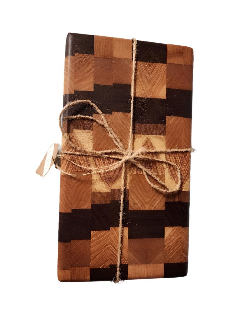 Handcrafted small end grain butcher block in black walnut, cherry, and maple wood, measuring 5" x 9" x 2".