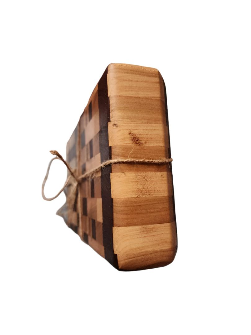 Handcrafted mini end grain chopping board made from black walnut, cherry, and maple wood with intricate pattern, tied with twine.