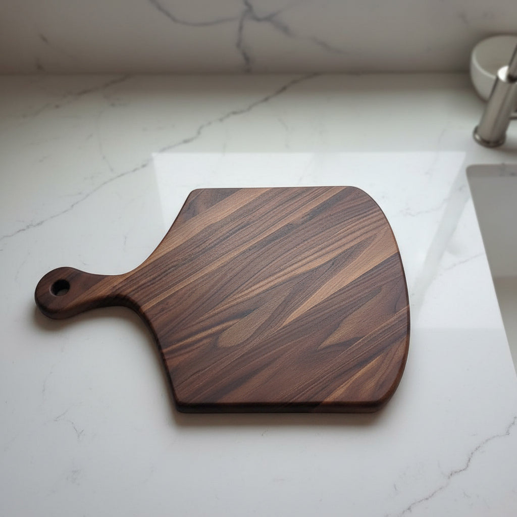 Black Walnut Pizza Peel on granite countertop.